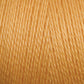 Close-up of 16/2 Bamboo Yarn by Maurice Brassard, showcasing tightly wound strands that exhibit a slight sheen. The texture appears smooth and silky, ideal for knitting or crocheting projects. This sustainable yarn boasts a vibrant golden yellow hue with consistent quality throughout, and its antibacterial properties further enhance its appeal.