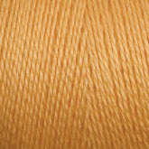 Close-up of 16/2 Bamboo Yarn by Maurice Brassard, showcasing tightly wound strands that exhibit a slight sheen. The texture appears smooth and silky, ideal for knitting or crocheting projects. This sustainable yarn boasts a vibrant golden yellow hue with consistent quality throughout, and its antibacterial properties further enhance its appeal.