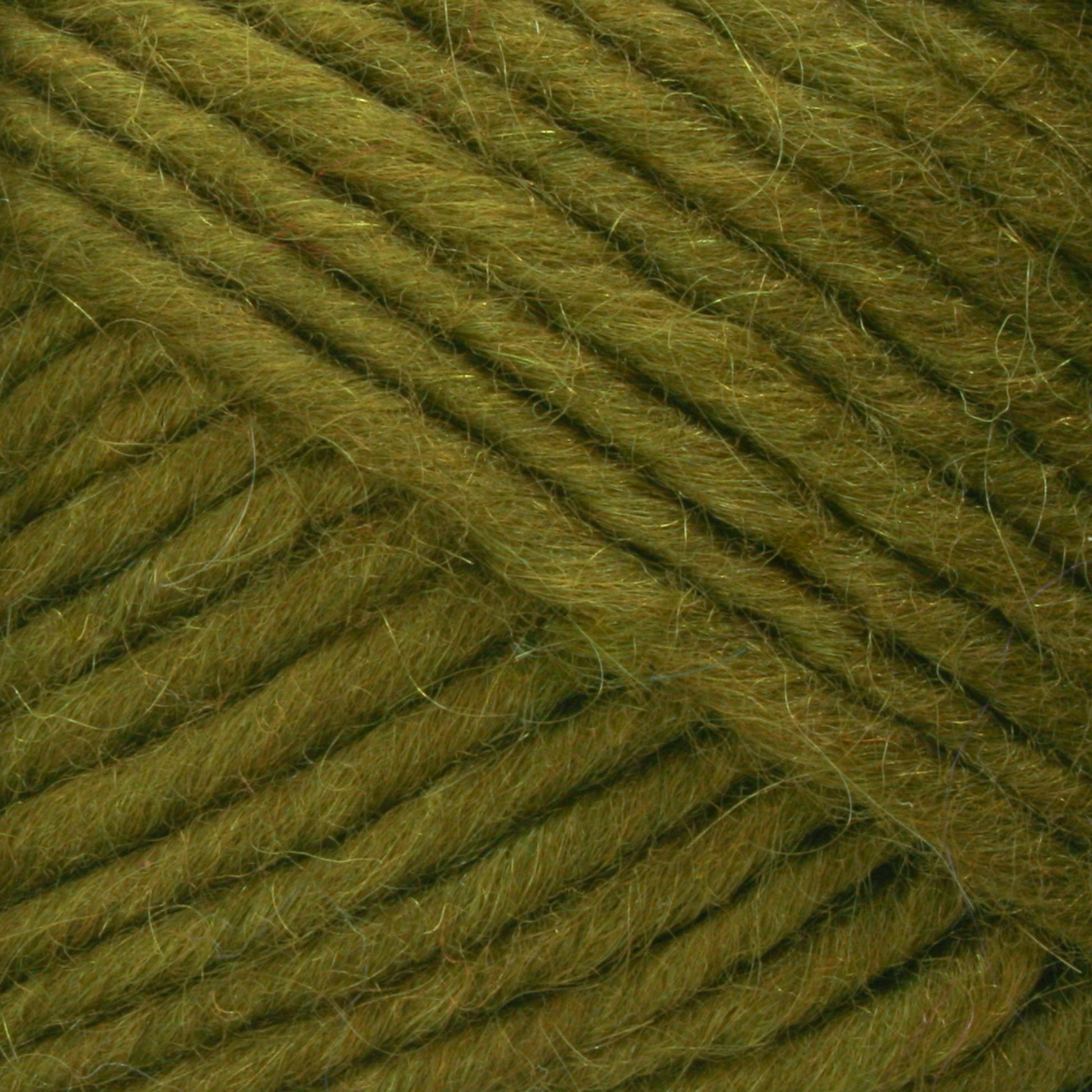 Close-up image of Brown Sheep's Lamb's Pride Bulky Yarn in a diagonal pattern. The fibers are soft and fuzzy, and the color is a vibrant shade of green with subtle variations and texture details visible, making it perfect for knitters and crocheters crafting cozy Icelandic sweaters.