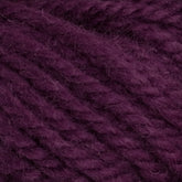 Close-up of Halcyon Yarn Classic Rug Wool in deep purple by Caledonian Dye Works, showcasing the texture and thickness of the strands. The yarn appears to be made of a soft, fuzzy material, suitable for knitting or crocheting. Perfect for rug weavers, this classic rug wool features a hand-dye that adds a unique touch to any project.