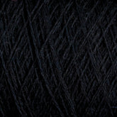 Close-up image of dark, tightly-wound JaggerSpun Maine Line 3/8 Yarn mini-cones by Jagger Brothers, Inc. The strands, arranged in a crisscross pattern, create a dense, textured surface. The dark hue and intricate pattern suggest a complex and rich appearance.