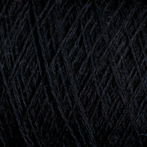 Close-up image of dark, tightly-wound JaggerSpun Maine Line 3/8 Yarn mini-cones by Jagger Brothers, Inc. The strands, arranged in a crisscross pattern, create a dense, textured surface. The dark hue and intricate pattern suggest a complex and rich appearance.