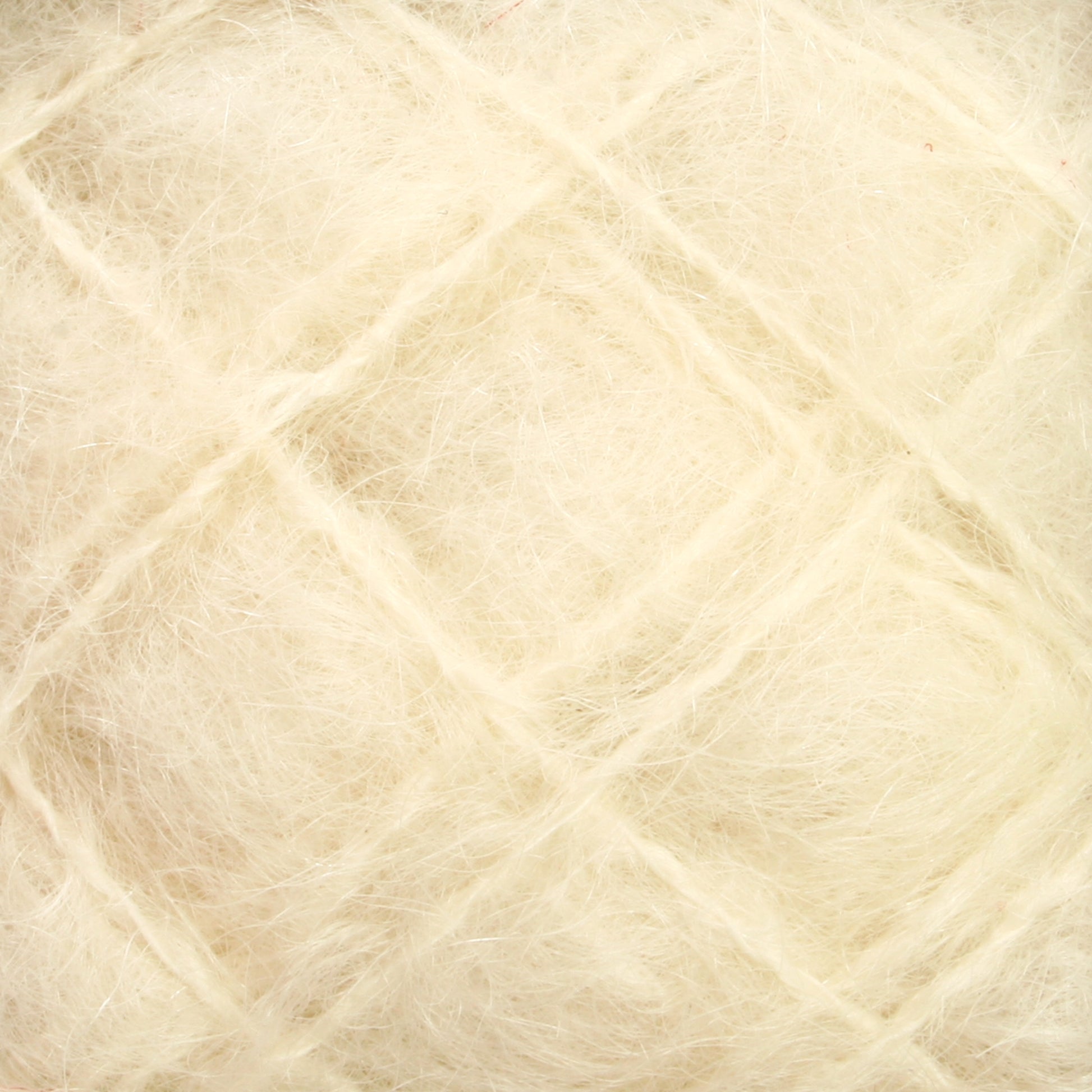 Close-up of Caledonian Dye Works' Victorian Brushed Mohair Yarn Mini Skein reveals a soft, white, fluffy texture with a fibrous, almost web-like appearance. The image captures the intricate intertwining of fine natural fibers reminiscent of luxurious mohair, creating a delicate, airy surface.