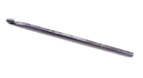 The handcrafted Knitter's Pride Symfonie Dreamz Wooden Crochet Hook from Accessories Unlimited, size K/10 (6.5 mm), boasts a dark color and smooth material. It features a curved hook at one end and size markings along the shaft, and it lies on a white background.