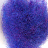 Close-up image of a fluffy, tangled mass of purple fibers, resembling a cloud of finely spun Harrisville Dyed & Carded Wool Fiber from Harrisville Designs. The fibers exhibit varying shades of heathered colors in purple and blue, creating a textured and intricate appearance.