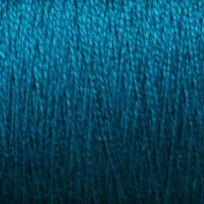 A close-up image of teal-colored 10/2 Pearl Cotton Yarn | Mini-cone from Supreme Corp. tightly wound into a ball. The texture of this versatile yarn is clearly visible, showcasing its soft, fibrous strands and impressive colorfastness.