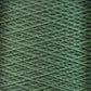 A close-up shot of a spool of Supreme Corp.'s 10/2 Pearl Cotton Yarn in green. The yarn on the mini-cone is tightly wound, forming a detailed crisscross pattern of strands across the image. The texture is distinct, and the color displays excellent colorfastness throughout its consistent shade of green.