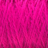 Close-up of bright pink Harrisville Shetland Yarn - Unwashed Cones by Harrisville Designs, showcasing its soft, fuzzy texture. The fibers are interwoven tightly, producing a vibrant and rich appearance. Reminiscent of Fair Isle knitting, this fluffy, wool-like material is an ideal choice for lightweight blankets, with details of individual strands clearly visible.