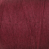 Close-up of a spool of Maurice Brassard's 8/2 Cottolin Organic Yarn, highlighting the texture and fine threads wound tightly together. The dark red yarn appears soft and slightly fuzzy with a consistent, rich color, perfect for weaving on a four shaft loom.