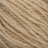 Close-up image of a skein of Harrisville Shetland Yarn - Unwashed Cones by Harrisville Designs, highlighting its twisted and soft texture. The fibers are tightly wound, presenting a uniform pattern in a neutral, light tan color—ideal for Fair Isle knitting designs or lightweight blankets.