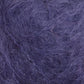 A close-up shot of Victorian Brushed Mohair Yarn by Caledonian Dye Works reveals a luxuriant texture featuring intertwined purple fibers, giving a fuzzy, hairy appearance. The chaotic and dense fibers create a slightly uneven surface with various shades of purple. This soft texture is reminiscent of luxurious mohair yarn or fabric, suggesting premium quality.