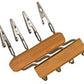 The Shadybrook Fringe Twister from Shadybrook Farm features two wooden bases, each equipped with a pair of metallic alligator clips attached to flexible metal arms. These clips are designed to securely hold small objects, making the tool ideal for precise tasks such as soldering, crafting, or working on delicate fringing projects.