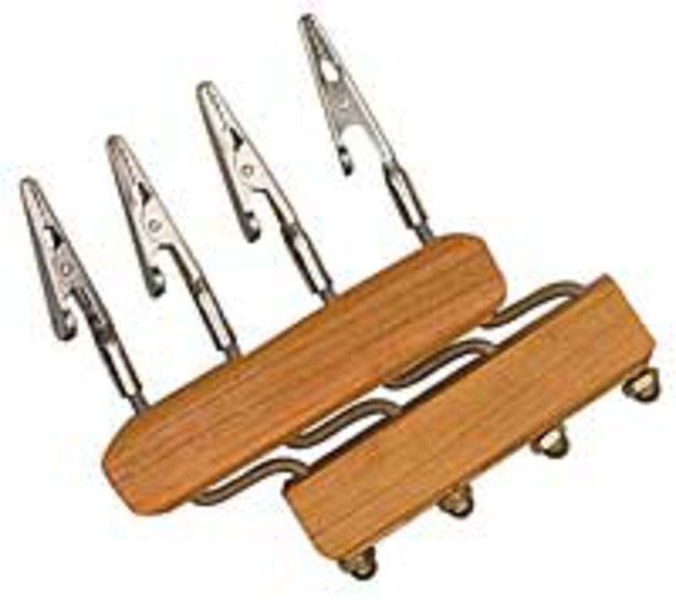 The Shadybrook Fringe Twister from Shadybrook Farm features two wooden bases, each equipped with a pair of metallic alligator clips attached to flexible metal arms. These clips are designed to securely hold small objects, making the tool ideal for precise tasks such as soldering, crafting, or working on delicate fringing projects.