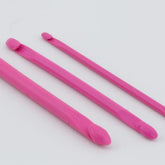 Three Fix-A-Stitch Tools by Accessories Unlimited, each in pink plastic and of varying lengths, are laid side by side on a white background. The tools, reminiscent of double-hooked instruments, have curved ends designed for prying tires off rims.