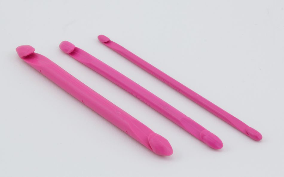 Three Fix-A-Stitch Tools by Accessories Unlimited, each in pink plastic and of varying lengths, are laid side by side on a white background. The tools, reminiscent of double-hooked instruments, have curved ends designed for prying tires off rims.