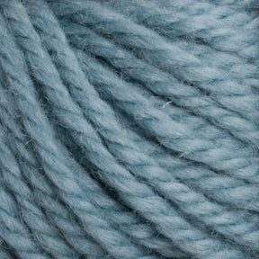 Close-up image of thick, light blue Halcyon Yarn Classic Rug Wool by Caledonian Dye Works entwined together, highlighting the fibers and texture of the material, ideal for rug weavers.