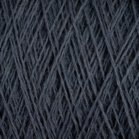 Close-up image of Jagger Brothers, Inc.'s JaggerSpun Maine Line 2/20 Yarn in dark gray, wound tightly around itself to form an intricate pattern of diagonal and crisscrossing lines. The texture appears soft yet dense, with the worsted spun strands showing slight variations in thickness.