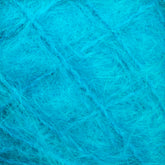 Close-up image of the Victorian Brushed Mohair Yarn | Mini Skein by Caledonian Dye Works, showcasing its vibrant blue fluffy texture. The soft mohair fibers are interwoven in a chaotic pattern, appearing delicate and airy to create a fuzzy and cozy visual effect.