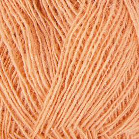 Close-up of Einband Lopi yarn by Berroco, Inc., showing intricate woven strands. The fibers are tightly spun and the texture appears soft and slightly fuzzy. The vibrant orange color is consistent throughout, highlighting the uniformity of this Icelandic wool skein.