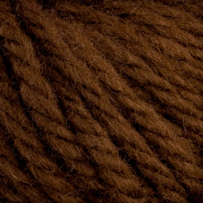 Close-up of Halcyon Yarn Classic Rug Wool from Caledonian Dye Works, displaying the fibers and texture of the thick, brown strands. The yarn appears soft and slightly fuzzy, with a rich, earthy hue typical of hand-dye techniques used by skilled weavers.