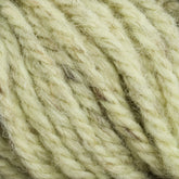 Close-up view of thick, light yellow Halcyon Yarn Classic Rug Wool | Strand by Caledonian Dye Works. Subtle brown speckles decorate the fibers, which are twisted together to create a textured and soft appearance reminiscent of classic rug wool. This yarn is perfect for discerning rug weavers seeking high-quality material.