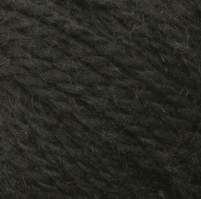 A close-up image of a textured, dark grey Harrisville Designs Peace Fleece Yarn. The fibers appear soft and slightly fuzzy, with a subtle shine from the natural wool and mohair blend. The yarn strands are densely intertwined, indicating it is tightly spun, making it perfect for worsted weight knitting projects.