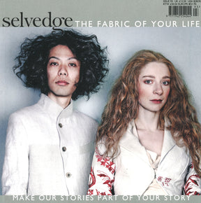 A man with curly dark hair and a woman with long wavy blonde hair stand side by side, both wearing light-colored, detailed jackets. Text on the image reads "Selvedge - Issue 93: Rethink: The Fabric of Your Life, Make Our Fashion Stories Part of Your Story.