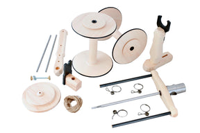 The Kromski Minstrel Wheel Great Flyer Set by Kromski North America is a wooden mechanical assembly kit featuring an array of components, including spools, rods, a handle, clamps, rope, screws, and other parts. These pieces are neatly arranged on a white background and appear to be for constructing a functional wooden device or tool.