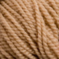 Close-up image of Norumbega, a beige-colored, thickly twisted yarn. The texture of this Aran weight yarn from Caledonian Dye Works is prominent, showcasing tightly wound fibers with a soft and slightly fuzzy appearance. Made from 100% U.S. wool, it promises durable fabric perfect for cozy sweaters and blankets.