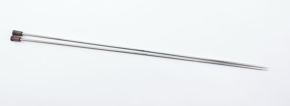 A pair of long, slim, Nova Platina Single Point Knitting Needles with small, colorful rectangular caps on one end. Made from hollow brass pipes and placed parallel to each other against a plain, light background, these Accessories Unlimited needles are both functional and stylish.