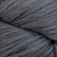 A close-up image of the Cumulus Cotton by Juniper Moon Farm reveals its soft, chunky gray yarn with fluffy, smooth fibers expertly twisted together, showcasing durable chainette construction. The even and consistent gray color throughout the entire strand makes it perfect for crafting weightless accessories.