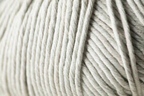 Close-up image of Jo Sharp Desert Garden Aran Cotton yarn, coiled and neatly wound into a ball. The light grey microfibre blend texture is visible, showing its softness and thickness. The individual strands from Kingfisher Yarn & Fibre are uniformly twisted, making it ideal for exceptional knitting performance.