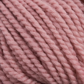 Close-up image of a ball of thick, twisted Norumbega yarn in a soft pastel pink color, showcasing its texture and fibers in detail. Ideal for weavers, this 100% U.S. wool yarn from Caledonian Dye Works promises both quality and beauty for your craft projects.