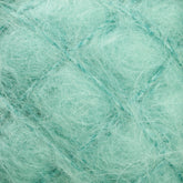 A close-up view of a soft, fuzzy mint green yarn with a delicate, airy texture from Caledonian Dye Works. The fibers in this Victorian Brushed Mohair Yarn appear wispy and loosely spun, creating a light and fluffy appearance reminiscent of luxurious mohair. The yarn strands intertwine to form a cozy and lightweight material perfect for Victorian-inspired projects.