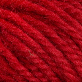 Close-up image of red yarn fibers intertwined together. The texture shows soft, woolen strands with slight variations in shading, reminiscent of Halcyon Yarn Classic Rug Wool | Strand by Caledonian Dye Works, creating a rich, vibrant appearance.