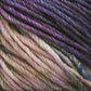 Close-up of multicolored Malabrigo Rios yarn by Malabrigo Yarn, featuring hues of purple, lavender, pink, and cream interwoven in a twisted pattern. The texture appears soft and thick, with the kettle-dyed colors blending smoothly into each other.