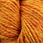 Close-up image of Peace Fleece Yarn by Harrisville Designs in orange and yellow variegated hues. The fibers appear thick and soft, with a textured and slightly fuzzy look. This wool and mohair blend's colors meld seamlessly to create a warm, vibrant effect ideal for worsted weight knitting projects.