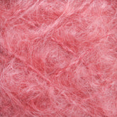 Close-up of the Victorian Brushed Mohair Yarn | Mini Skein by Caledonian Dye Works. The textured, pink fluffy fibers are intertwined, creating a soft and fuzzy appearance reminiscent of delicate Victorian yarns. The overall effect is light and fibrous, evoking the charm of natural fiber textiles.