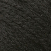 Close-up image of Peace Fleece Yarn by Harrisville Designs, capturing the visible fibers and texture. The yarn appears to be tightly wound, showcasing its thickness and slight fuzziness. The wool and mohair blend is uniformly black with subtle variations in shading due to the texture.