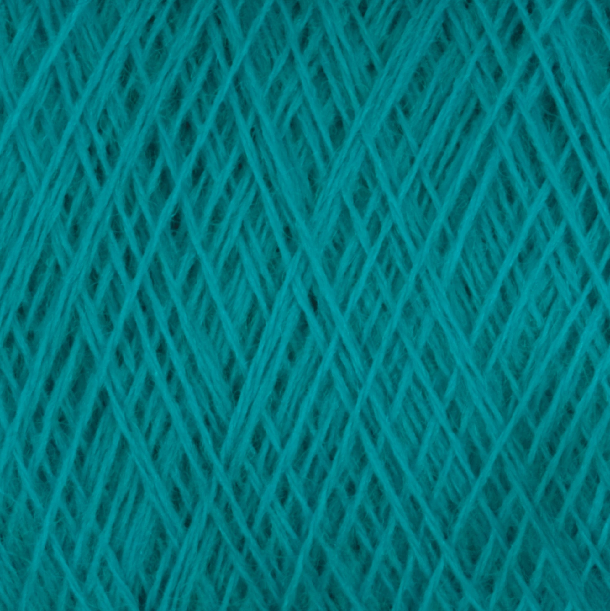 Close-up image of Jagger Brothers, Inc.'s JaggerSpun Maine Line 3/8 Yarn | Mini-cone, showcasing the intricate crisscrossing fibers arranged in a tight, overlapping pattern. The texture appears soft with subtle variations in shade caused by the lighting and fiber arrangement.