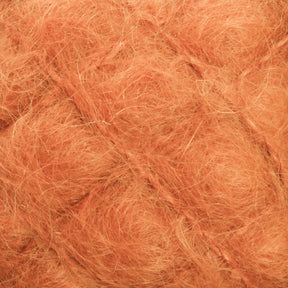 Close-up image of soft, fuzzy, and slightly tangled orange fibers from Caledonian Dye Works' Victorian Brushed Mohair Yarn. The intricate texture features fine strands intersecting in a grid-like pattern with wisps extending in various directions, reminiscent of the luxurious appeal typical of Victorian yarns.