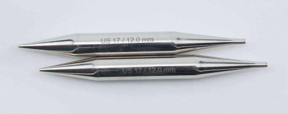 Two metallic knitting needle tips, likely from the Accessories Unlimited Nova Platina Interchangeable Knitting Needles, 4.5" Tip, are aligned vertically against a plain white background. Each tip is engraved with "US 17 / 12.0 mm," indicating the size. The sleek, smooth, and tapered tips resemble hollow brass pipes in their craftsmanship and elegance.