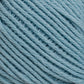 Close-up of Brown Sheep's Cotton Fleece in light blue, showing the texture and detail of the tightly wound strands. The fibers appear soft and slightly fuzzy, with a consistent twist pattern throughout, making it perfect for knitting patterns that highlight soft pastels.