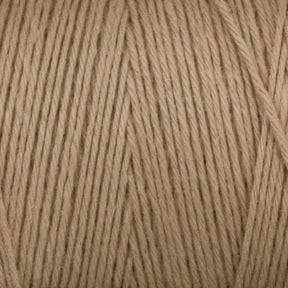 A close-up image of Maurice Brassard's Cotton 8/8 Carpet Warp yarn, tightly wound into a skein. The beige threads are uniformly thin and neatly aligned, creating an orderly pattern. The texture of this unmercerized cotton yarn appears soft and smooth, ideal for knitting and crochet projects.