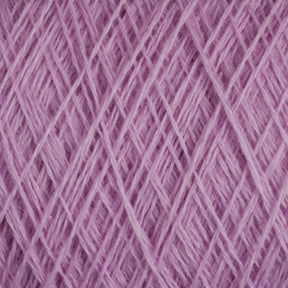 Close-up view of a tightly wound ball of lilac-colored JaggerSpun Maine Line 3/8 Yarn | Large Cone from Jagger Brothers, Inc. The yarn is arranged in a crisscross pattern, showcasing its soft and fuzzy texture. The image highlights the fine threads and the uniformity of the winding, typical of this soft medium-grade wool.