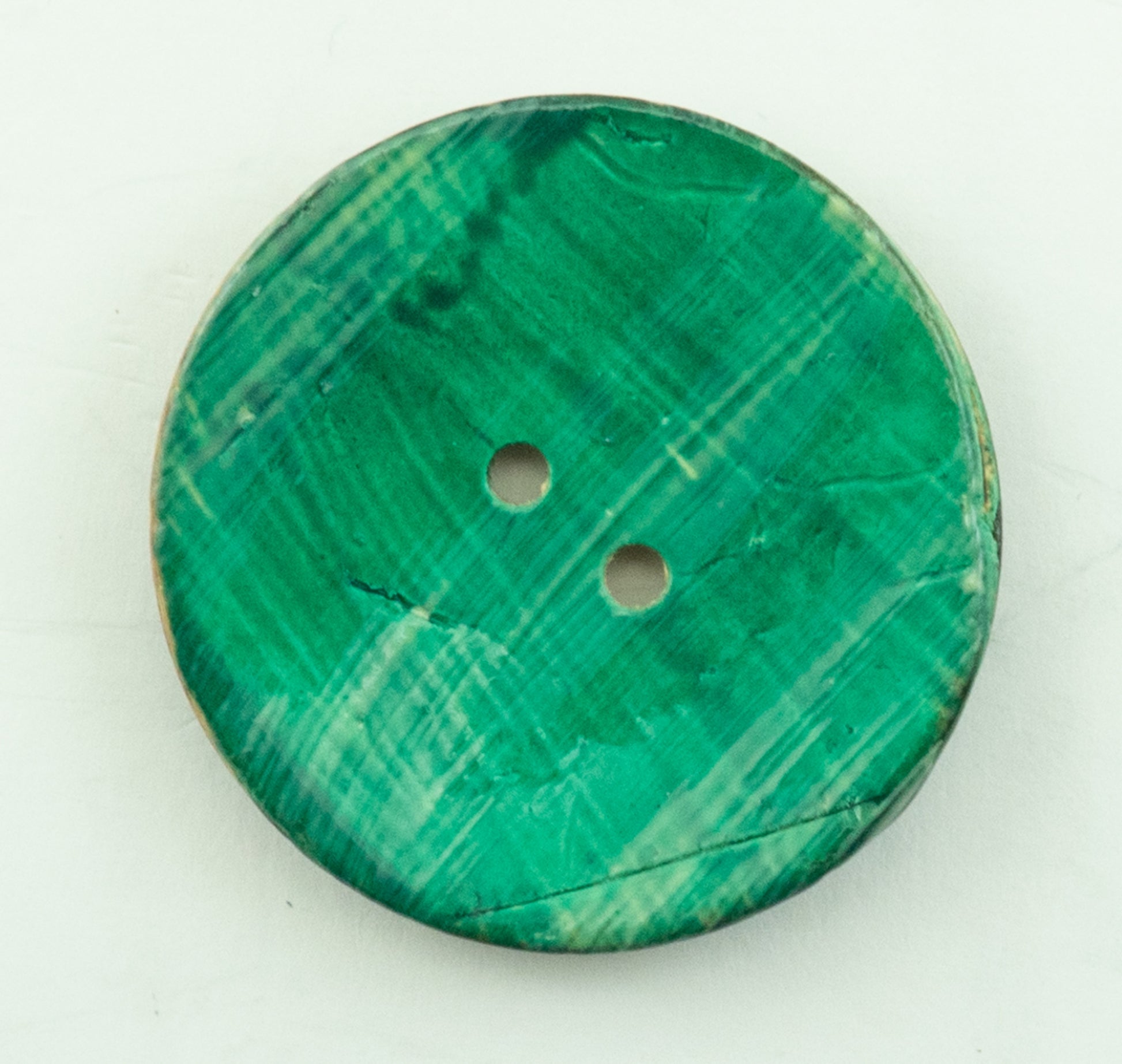 The Coconut Stria Button by Buttons Etc. features a round, marbled green design with a 1⅝" diameter and two central holes. It is displayed against a plain white background.