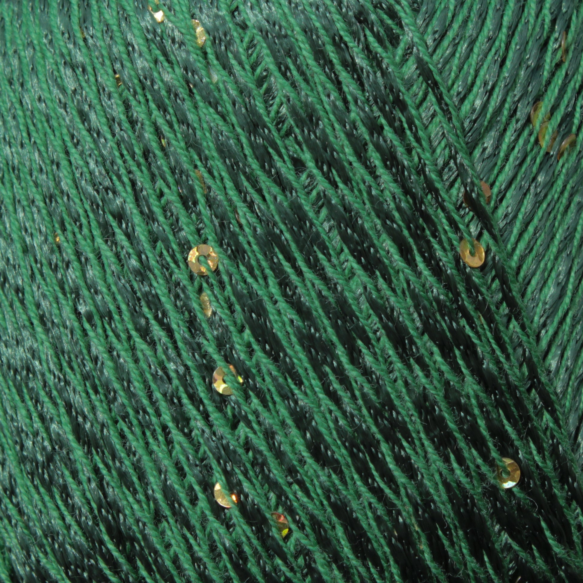 Close-up image of Jo Sharp Lumina yarn by Kingfisher Yarn & Fibre, showcasing green shimmery threads interwoven with golden sequins to create a textured and sparkly surface. The DK weight strands are densely packed, with golden sequins scattered throughout, adding an elegant decorative touch.