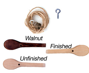 A Kromski Brake Band Set for Fantasia with Peg from Kromski North America, accompanied by a keyring and hook next to it. Below are two wooden spoons: one labeled "Walnut Finished" featuring dark staining, and the other labeled "Unfinished" showcasing a natural wood appearance.