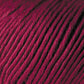 A close-up image of tightly wound, maroon-colored Jo Sharp Soho Summer DK Cotton Yarn from Kingfisher Yarn & Fibre, showcasing the texture and strands of the fiber. The yarn appears smooth and is closely packed in circular patterns, suggesting it is part of a larger skein or ball.