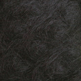 Here's a close-up view of the Victorian Brushed Mohair Yarn | Large Skein by Caledonian Dye Works. It features a dense, textured mass of dark and slightly wavy fibers. The colors range from dark gray to nearly black, with some lighter gray strands intermingled. This luxurious mohair appears tangled and intertwined, creating a chaotic, organic pattern reminiscent of Victorian yarns.